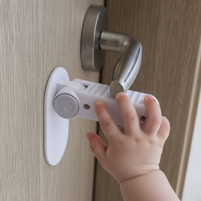 bloque porte bebe blanc main bébé essaie ouvrir poignée ronde chromée levier bouton caché