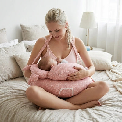 coussin d allaitement rose maman blonde assise lit allaite bébé bretelles
